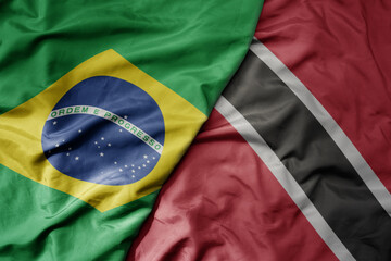 big waving realistic national colorful flag of brazil and national flag of trinidad and tobago .