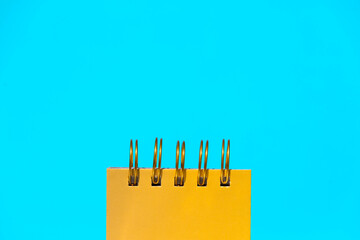 Metal binding spiral of notepad in blue studio