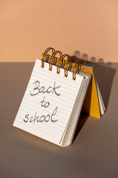 Opened spiral notebook with hardcovers with message back to school