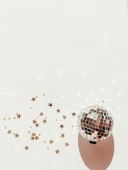 Minimal flat lay of Christmas or New Year, gold and silver party season decorations on white background.