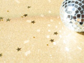 Greeting card - New year or Christms with silver disco ball and golden star shape glitter on gold shine background