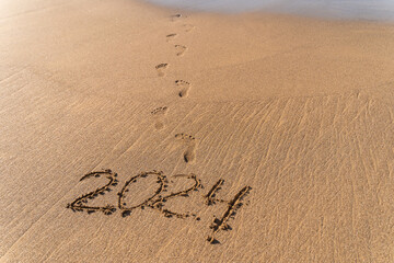 2024 hand written in sand on a beautiful beach