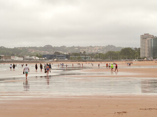 Beach at low tide in a city. Gijon. Asturias. Spain