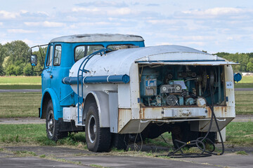 Close-up an old airfield fuel tank truck with open compartment the refuelling control station