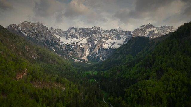 Mountains with a block field and snow around the Zgornje Jezersko valley in Slovenia aerial view during a beautiful springtime day with the mountain range around the Grintovec mountain peak.