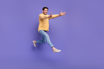 Fototapeta na wymiar Full body cadre of jump friendly brunet hair student man trendy clothes hugs overjoyed person running isolated on violet color background