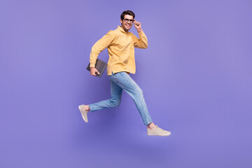 Fototapeta na wymiar Full size body photo of run active leader guy professional it specialist working remote carry netbook isolated on violet color background