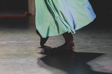 Ballet dancers couple during performance repetition, classic ballet rehearsal practicing in ballroom, view of legs in pointe shoes, ballerina and ballet dancer on a concert hall theatre stage © tsuguliev