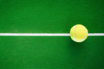 Tennis. Spring sport composition with yellow tennis ball in white line on a green background of tennis court with copy space. Sport and healthy lifestyle. The concept of outdoor game sports. Flat lay - Powered by Adobe
