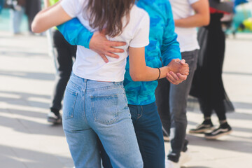 Couples dancing traditional latin argentinian dance milonga outdoor in the city streets, tango salsa bachata kizomba lesson, outdoors dance school class festival in a summer sunny day