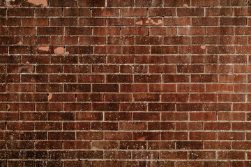 Background of old vintage brick wall. Cracked red grunge brick wall. Pattern for design and interior. 
