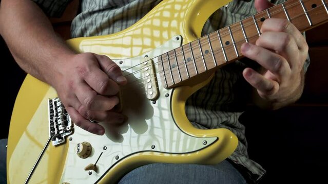 Man playing electric guitar using tremolo. 4k video footage UHD 3840x2160