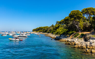 Ile Saint Honorat island panorama with forest coast and yachts on Mediterranean Sea waters offshore Cannes at French Riviera in France - 633340941