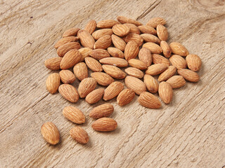 Delicious nuts and dry fruits on the background, close up style, in the plate still life.