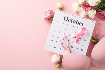 Pink-themed health design. Top view arrangement of October calendar, pink ribbon, bra, and eustoma...