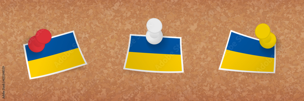 Wall mural ukraine flag pinned in cork board, three versions of ukraine flag.