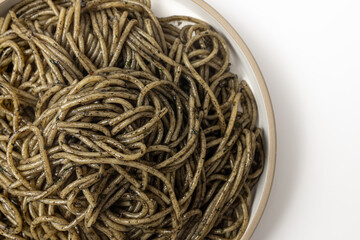 Pasta with squid ink sauce on a white background