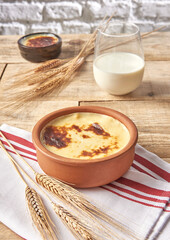 Rice pudding close up wooden table background and milk.