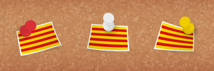 Catalonia flag pinned in cork board, three versions of Catalonia flag.