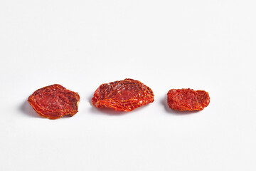 Delicious dry tomato and dry fruits on the background, close up style, in the plate still life.