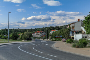 Fototapeta na wymiar Asphalt road to the port on the island of Rab in Croatia