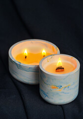 Decorative candles burn in the apartment on a black background