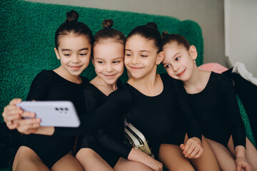 A group of girls doing gymnastics at school take a selfie