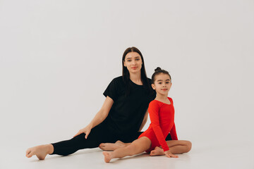 Gymnastics coach and student looking at camera