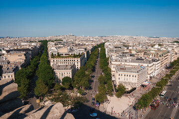 Fototapeta premium Oblique view of Paris cityscape from the Eiffel Tower on a sunny day with blue sky.