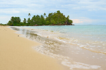 untouched beach  with coco palms on sandy beach and blue sea. Summer vacation and tropical in west sumatra indonesia