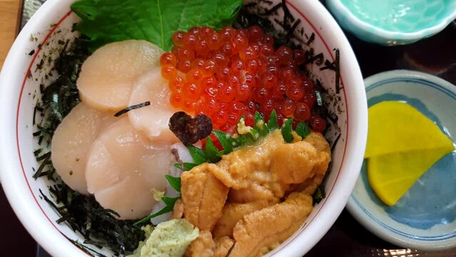 Hakkaido raw seafood rice topping scallop sea urchin and salmon roe hotate uni ikura