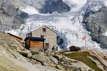 Cabane du Mountet in front of Glacier with Swiss Flag