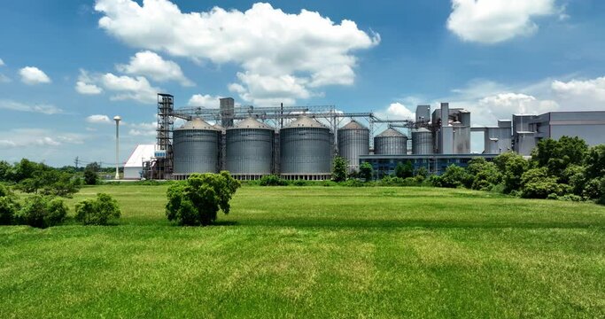 Plant for the drying and storage tank stainless silo grain. Rice plant in the middle of fields.