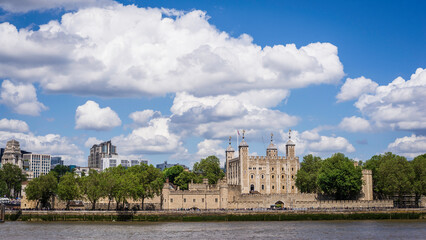 Fototapeta na wymiar London, United Kingdom, 21 june 2023:The Tower of London castle former prison River Thames museum International Landmark architecture sunny cloudy sky Europe. his majesty's royal palace and fortress