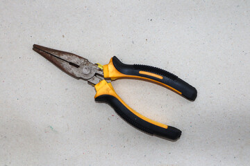 Obraz premium Yellow pliers and black pliers on a white background,close up photo.