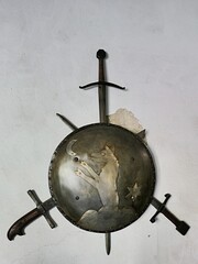 Round steel shield with emblem of wolf on cloud catching moon, star behind his back and three...