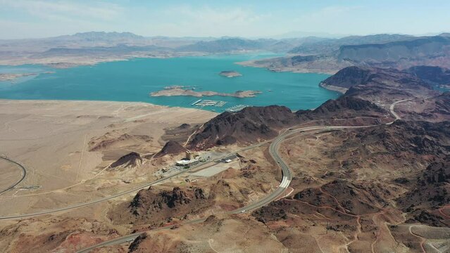 Aerial Video view - desert landscape -  with a pan to the left from Lake Mead to Boulder City in Nevada, USA with Mountain Landscape in background,  - aerial video footage