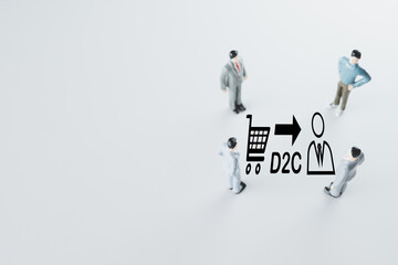 Fototapeta premium D2C(Direct To Customer),Online shopping,ecommerce,Home delivery,Online store concept.A Business team stand on right side photo and focus D2C icon over wihte background with copyspace.
