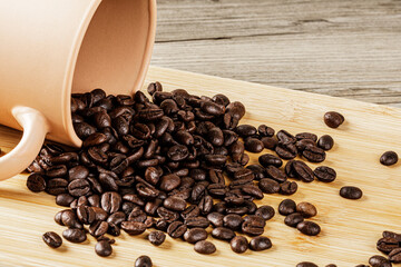 Delicious Roasted Coffee Beans on a wooden background