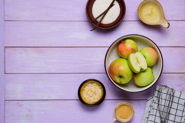 Ingredients for cooking puffed apple mousse on a purple wooden background. Desserts apples.