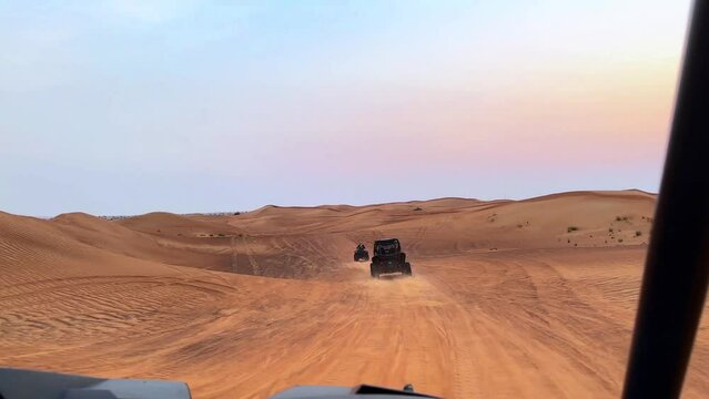 Riding buggies in the desert during sunset, extreme sand riding, buggy ride in the desert, desert sunset