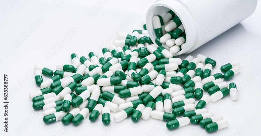 Canvas Prints green and white capsule pills spilled out of a white plastic bottle. pharmaceutical industry. prescr