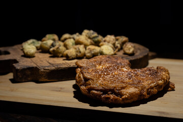 Fried pork chop dinner with fried okra.