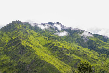 Fototapeta na wymiar Breathtaking Green Landscape with Foggy Mountains and Waterfalls during Monsoon in Nepal