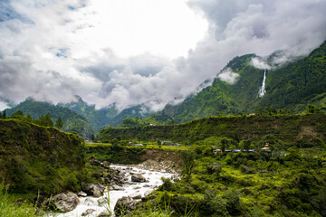 Obraz premium Breathtaking Green Landscape with Foggy Mountains and Waterfalls during Monsoon in Nepal