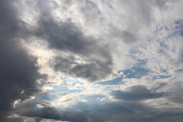 A cloudy sky with sun rays