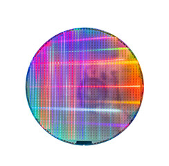 silicon wafer with microchips reflecting different colors.