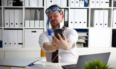 Man wearing suit and tie in goggles and snorkel make selfie with cellphone at office ready to take off portrait. Count days to leave annual day off workaholic freedom fun tourism resort idea concept