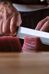 Male hands slicing fresh bluefin tuna loin