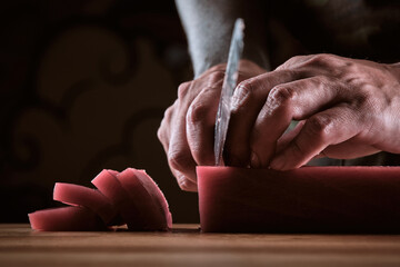 Male hands slicing fresh bluefin tuna loin